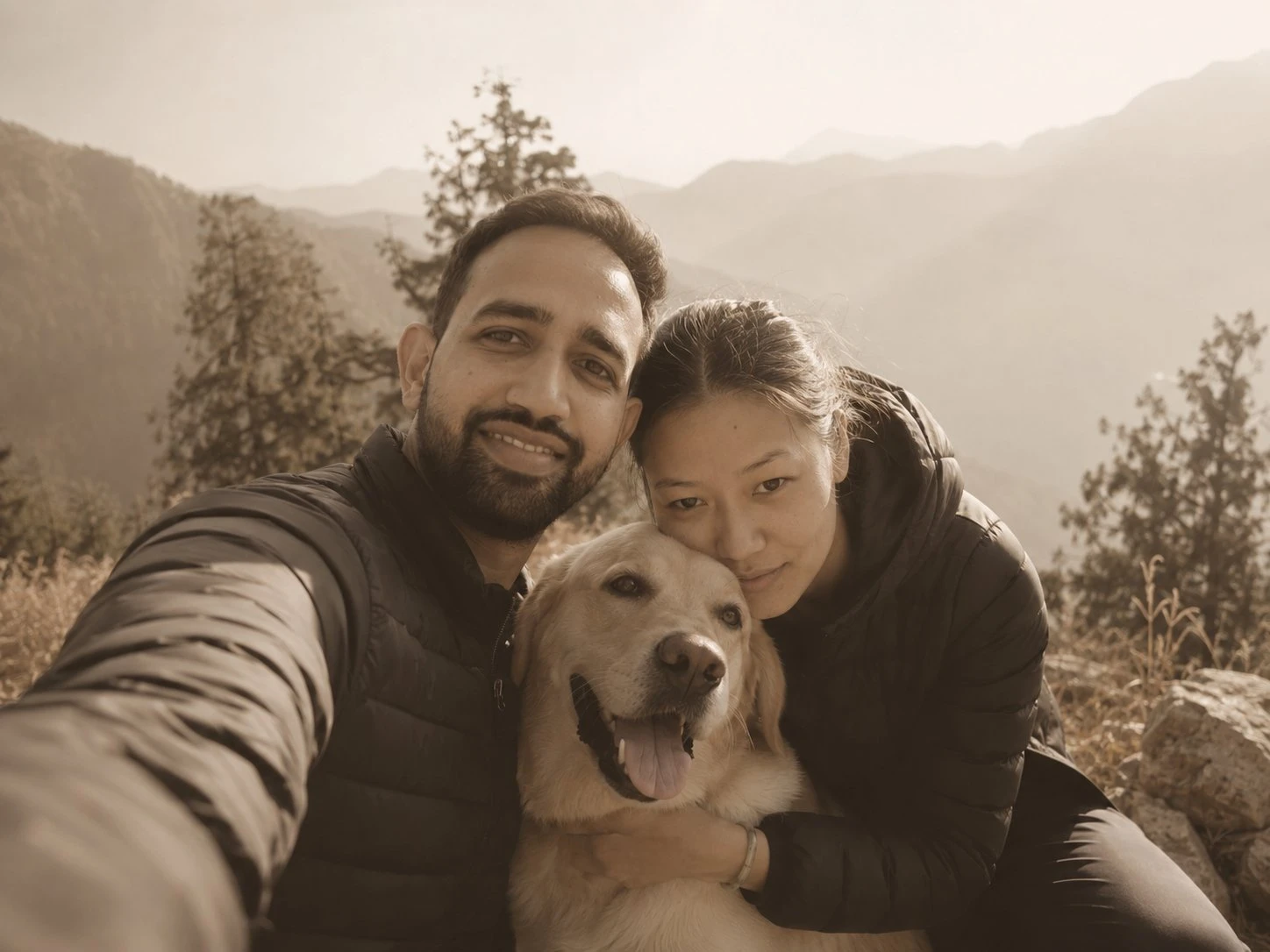 Rahul with Anisha and their dog Newton, outdoors